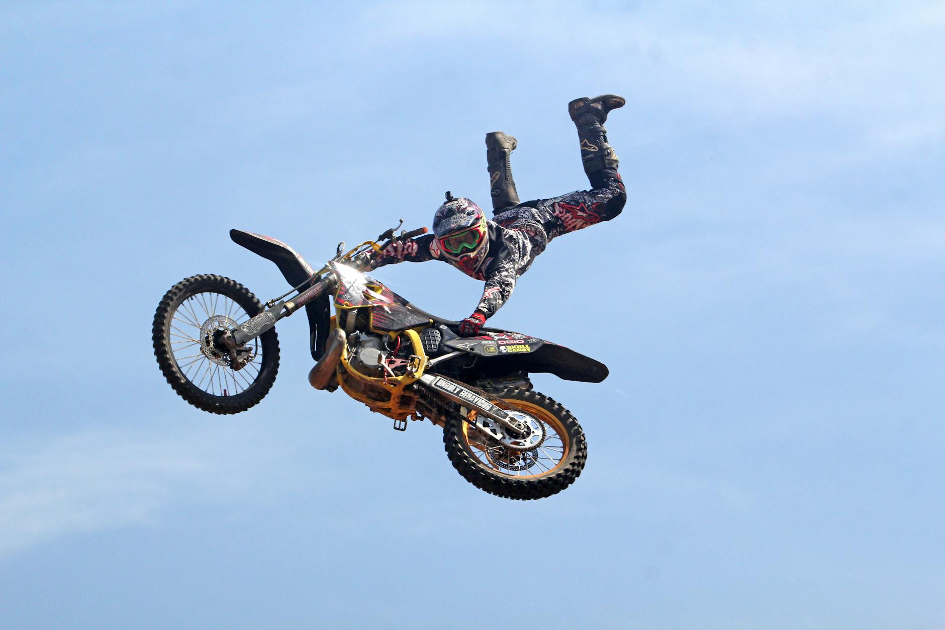 man riding orange motocross dirt bike